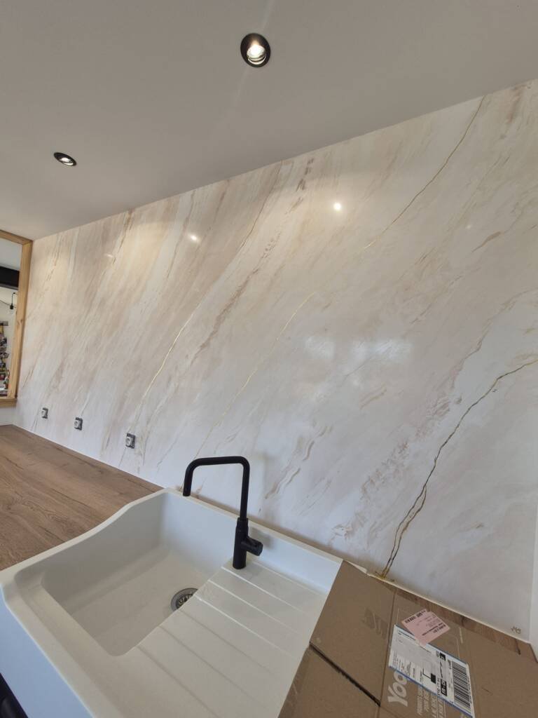 Mur en stucco beige, effet marbre, dans une cuisine moderne, plan de travail en bois